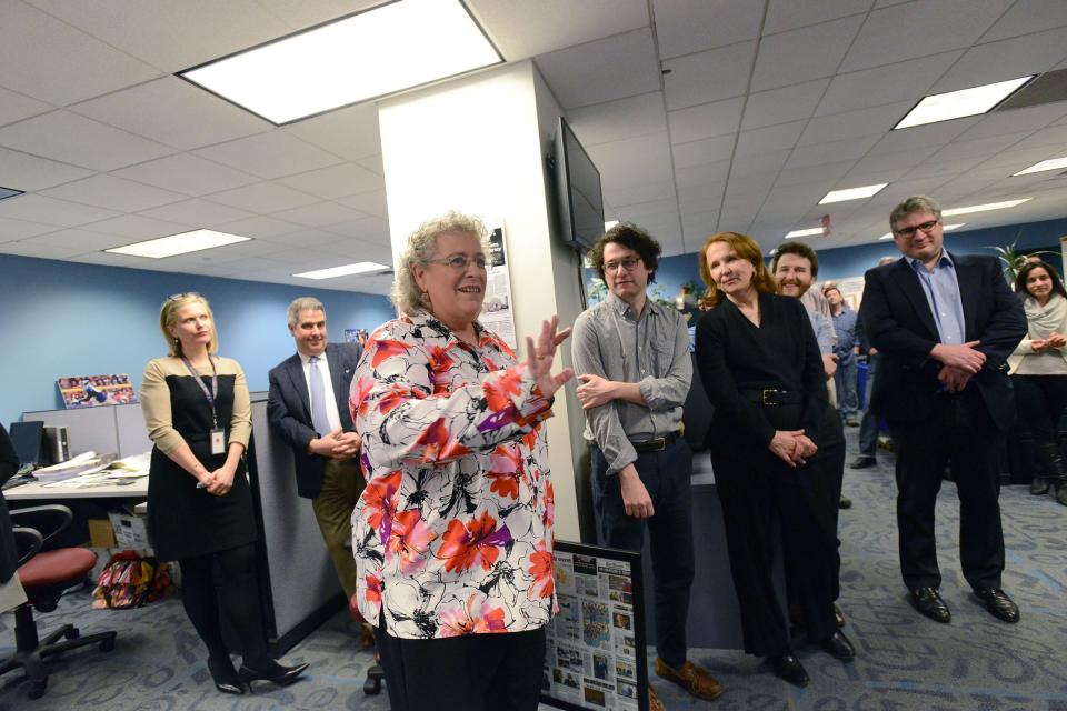 Marty Gottlieb, Editor of The Record is honored in a newsroom gathering of The Record and Herald News as staff members thanked him. Mr. Gottlieb was joined by his wife, Janet, and sons, Ben and Graham, as well as, Malcolm A. Borg, Chairman of the Board, North Jersey Media Group, which owns The Record; Stephen A. Borg, President and Publisher, North Jersey Media Group; and, Jennifer A. Borg, V.P. and General Counsel, North Jersey Media Group. Deirdre Sykes, Dir. of Assignment, presents a framed collage of front pages, then hugs Mr. Gottlieb.  January 28, 2016.