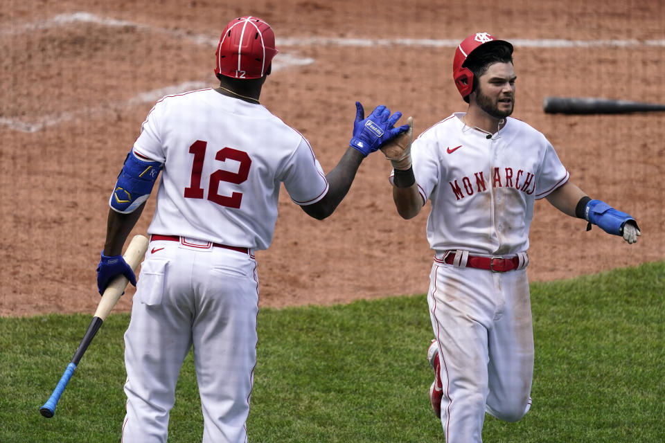 Kansas City Royals' Andrew Benintendi celebrates with Jorge Soler (12) after scoring on a sacrifice fly hit by Hanser Alberto during the seventh inning of a baseball game against the Detroit Tigers Sunday, May 23, 2021, in Kansas City, Mo. (AP Photo/Charlie Riedel)