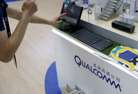 FILE PHOTO: A man visits Qualcomm's booth at the Global Mobile Internet Conference (GMIC) 2017 in Beijing, China April 28, 2017. Picture taken April 28, 2017. REUTERS/Jason Lee/File Photo