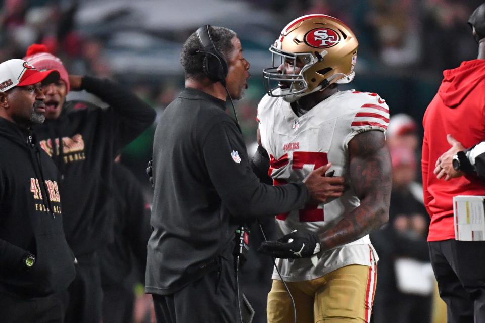 San Francisco 49ers linebacker Dre Greenlaw (57) talks a with a coach after being ejected against the Philadelphia Eagles during the third quarter at Lincoln Financial Field.