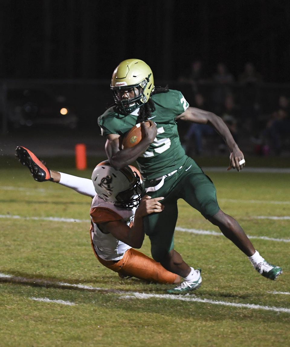 Fleming Island tailback Samuel Singleton sidesteps to escape a tackler against Atlantic Coast. The rising senior committed to Florida State football.