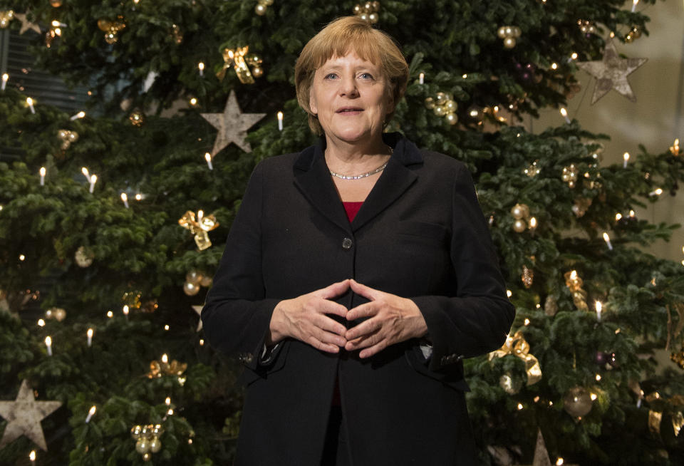 German chancellor Angela Merkel stands in front of a huge Christmas Tree, she just received, in the chancellery in Berlin, Thursday Nov. 29, 2012. (AP Photo/dapd/ Clemens Bilan)