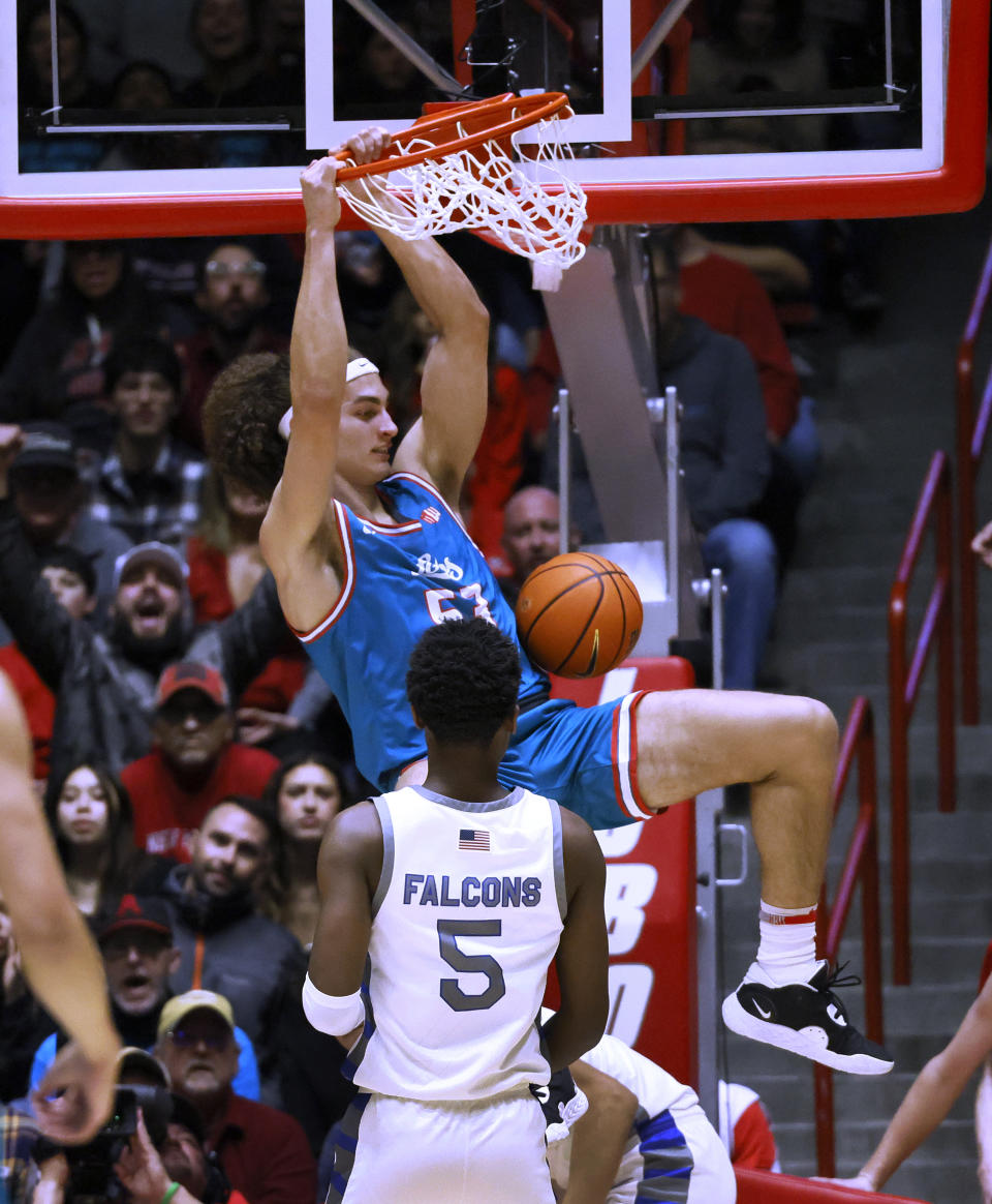 New Mexico's Josiah Allick dunks in front of Air Force guard Ethan Taylor during the first half of an NCAA college basketball game in Albuquerque, N.M., Friday, Jan. 27, 2023. (AP Photo/Eric Draper)