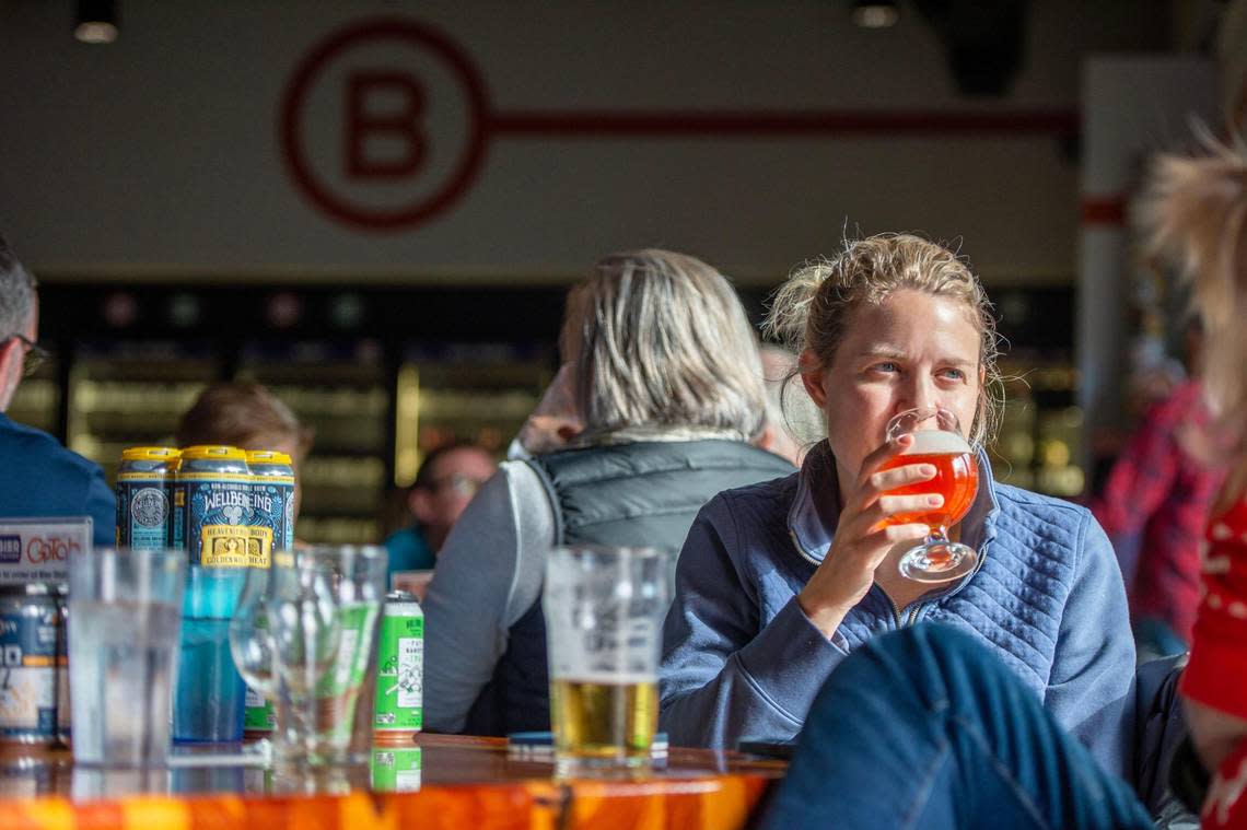 Lindsey Day enjoys a drink with her family at Bier Station on Saturday. Bier Station is closing after being purchased by City Barrel Brewing.