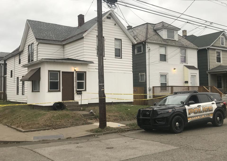 Erie police are searching for a suspect after they said a 25-year-old man who was holding a 1-year-old child outside of a residence in the 700 block of East 25th Street was shot in the head and killed on Friday.