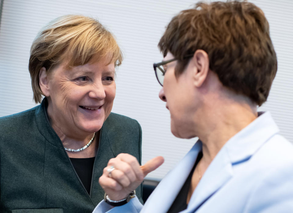 11 February 2020, Berlin: German Chancellor Angela Merkel (l, CDU) and Annegret Kramp-Karrenbauer (CDU), Minister of Defence and CDU Federal Chairwoman, talk at the beginning of the session of the CDU/CSU parliamentary group in the German Bundestag. Photo: Bernd von Jutrczenka/dpa (Photo by Bernd von Jutrczenka/picture alliance via Getty Images)