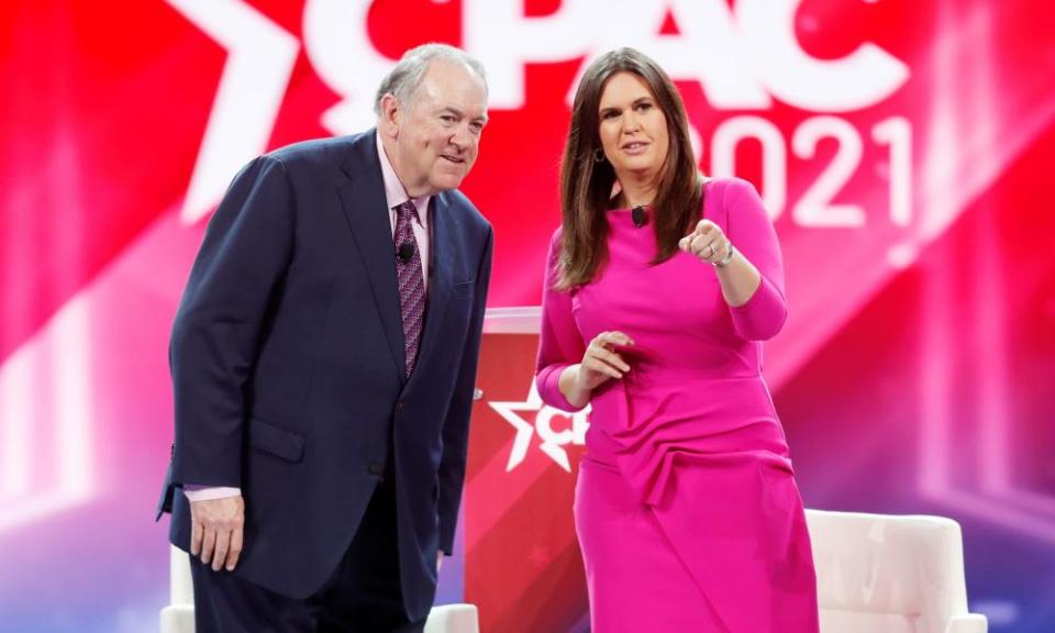 The former Arkansas governor Mike Huckabee on stage with his daughter Sarah, the former White House secretary