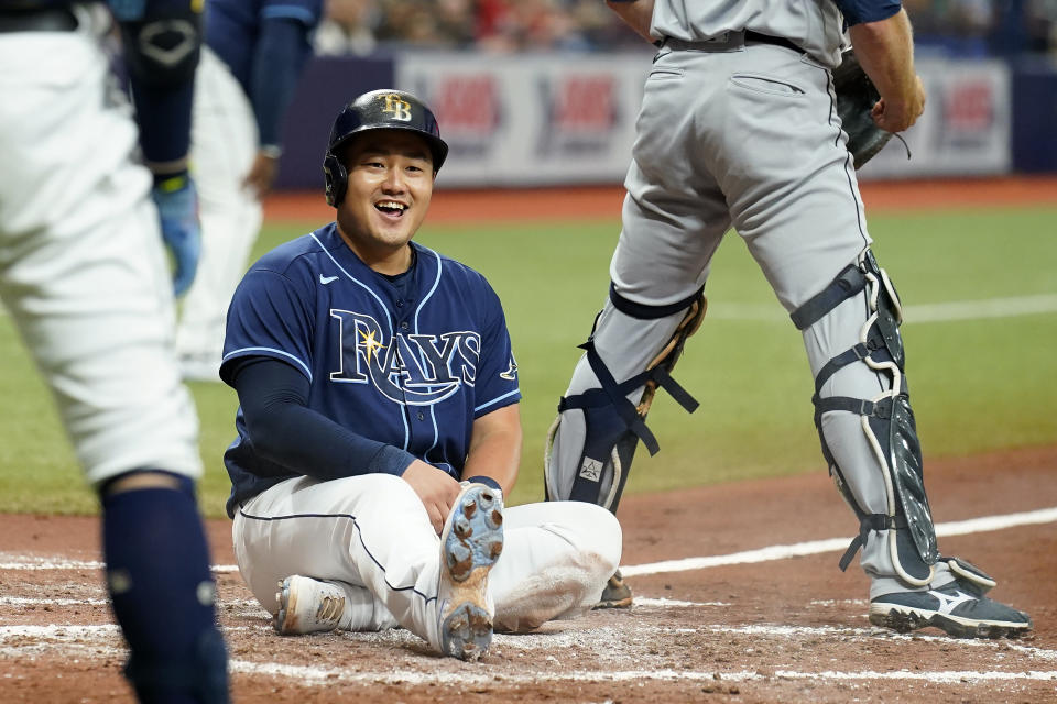 Tampa Bay Rays' Ji-Man Choi laughs after scoring on a two-run triple by Randy Arozarena off Seattle Mariners starting pitcher Logan Gilbert during the third inning of a baseball game Wednesday, Aug. 4, 2021, in St. Petersburg, Fla. (AP Photo/Chris O'Meara)