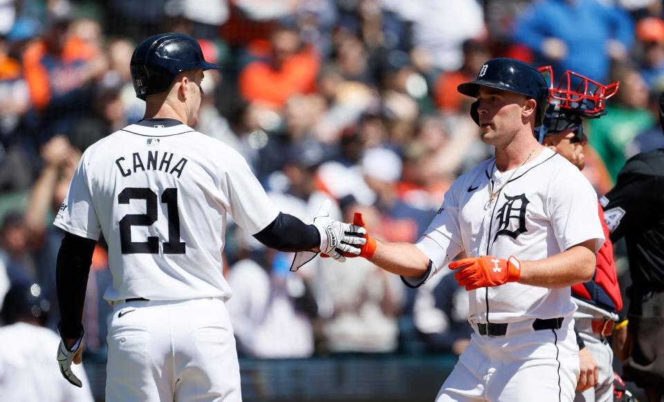Tigers right fielder Kerry Carpenter, right, celebrates with left fielder Mark Canha after hitting a two-run home run against the Twins that scored the pair during the first inning of Game 1 of the doubleheader on Saturday, April 13, 2024, at Comerica Park.