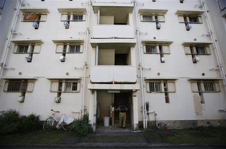 An elderly woman climbs up the stairs at Kasumigaoka apartment complex, which is located near the National Olympic Stadium in Tokyo September 18, 2013. REUTERS/Issei Kato