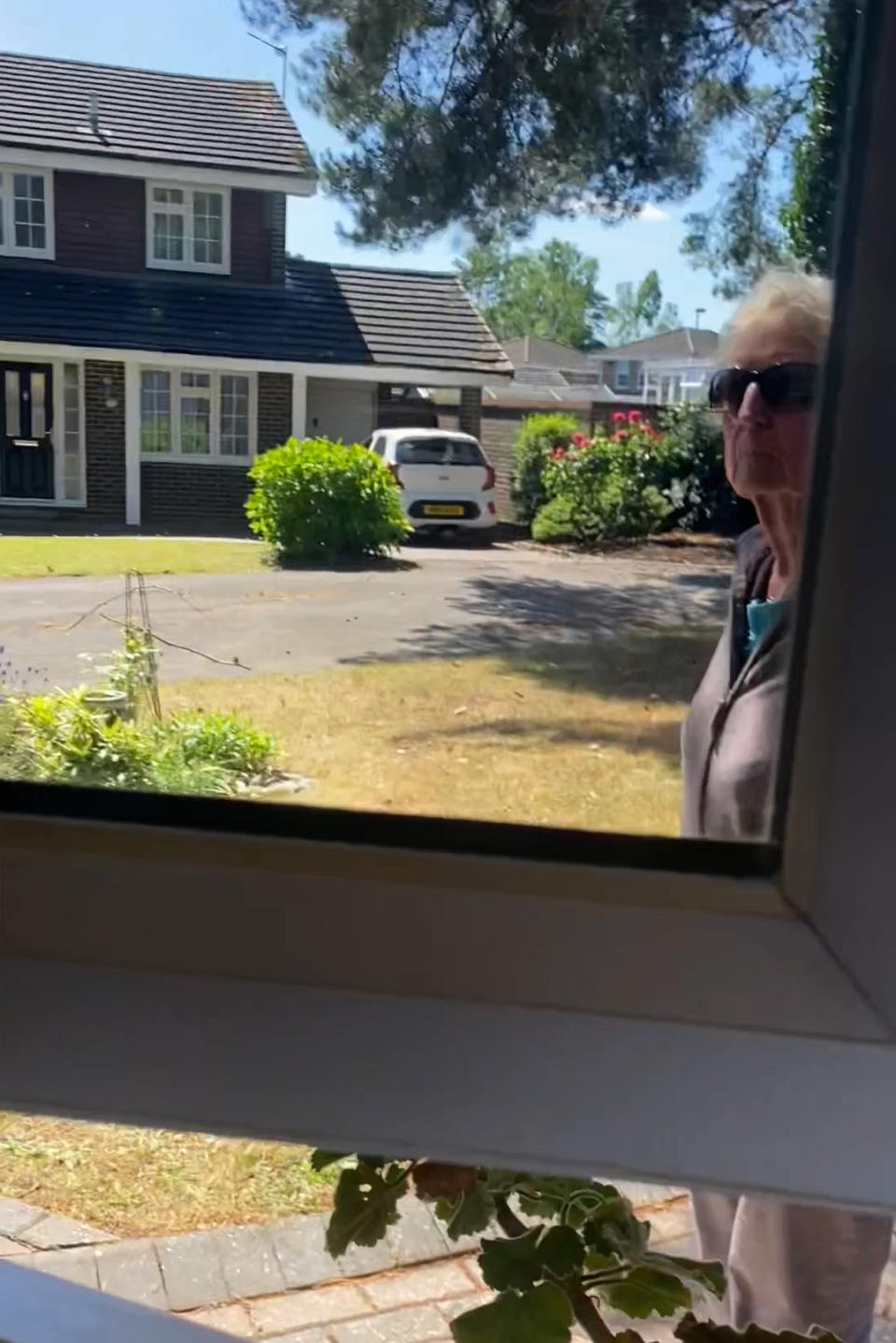 Eunice Day at the window of her neighbour's kitchen where she carried out her assault. (BNPS)