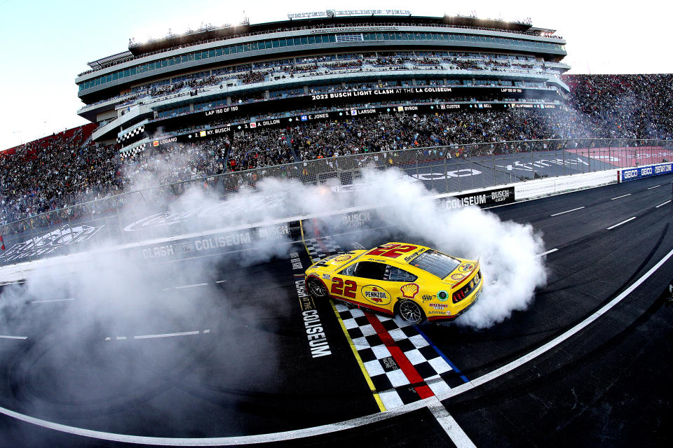 LOS ANGELES, CALIFORNIA - FEBRUARY 06: Joey Logano, driver of the #22 Shell Pennzoil Ford, celebrates with a burnout after winning the NASCAR Cup Series Busch Light Clash at the Los Angeles Memorial Coliseum on February 06, 2022 in Los Angeles, California. (Photo by Sean Gardner/Getty Images)