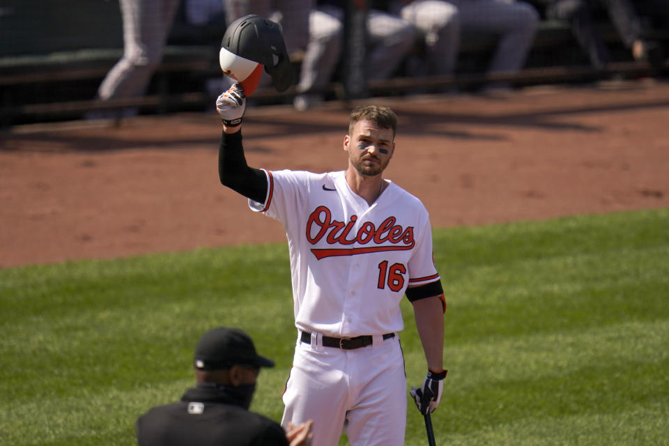 Baltimore Orioles' Trey Mancini tips his helmet as fans give him a standing ovation prior to batting against the Boston Red Sox during the first inning of a baseball game, Thursday, April 8, 2021, on Opening Day in Baltimore. (AP Photo/Julio Cortez)