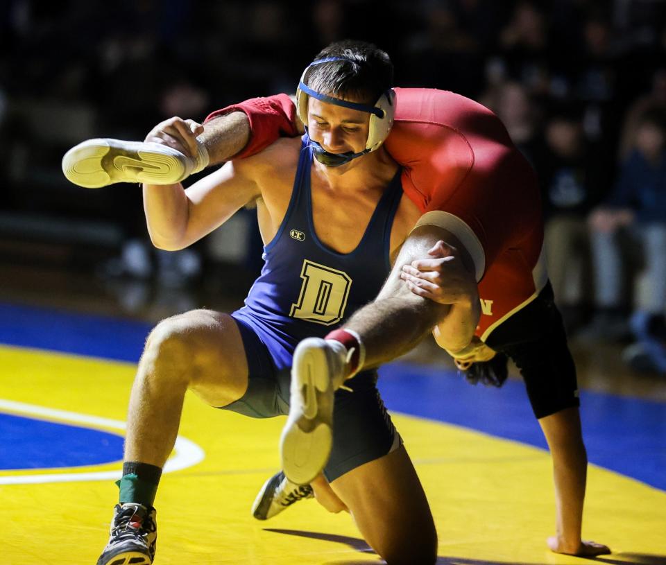 Owen Motylinski of Dundee lifts Monroe's Angel Rincon in the 165-pound finals at the 51st annual Monroe County Sheriff's Invitational Saturday. Motylinski logged a pin with 9 seconds left in the match.