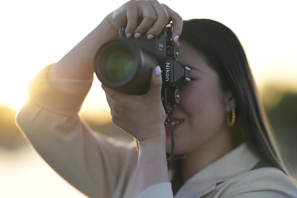 Photographer with Nikon Z f at golden hour