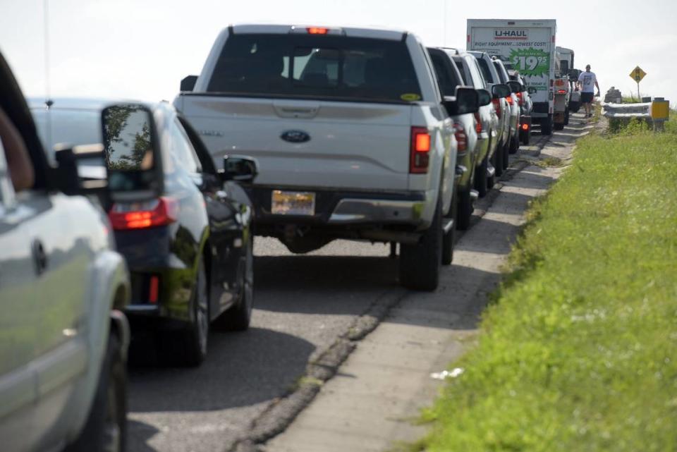 Cars wait in an incredibly long line on U.S. 301 to get lumber at 84 Lumber in Bradenton Friday ahead of the oncoming Hurricane Irma.