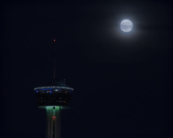 The Blue Moon full moon of 2015 rises behind the Tower of America in San Antonio, Texas in this view from skywatcher by Maj Shenandoah Sanchez on July 31, 2015.