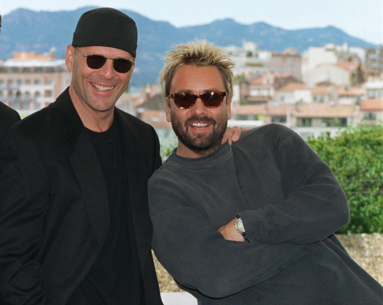 French director Luc Besson (R) leans against US actor Bruce Willis (L) during a photo call for their film 