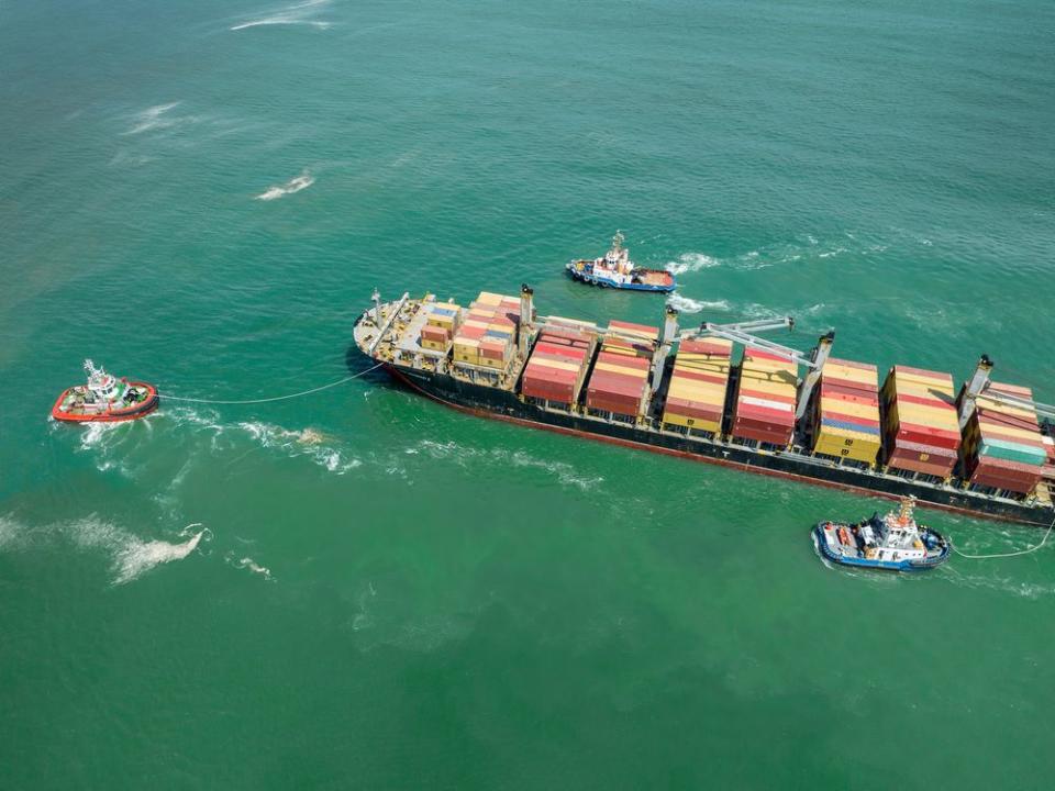  Tug boats guide a container ship into the Port of Arica on August 21, 2022 in Arica, northern Chile.