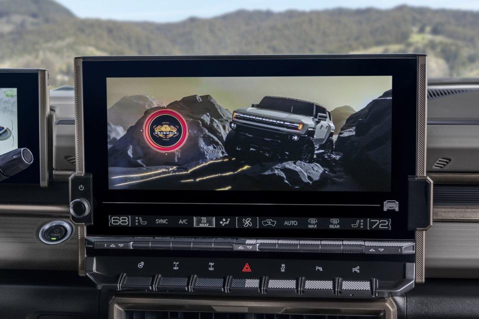 close up of the 2024 gmc hummer ev suv’s 134 inch infotainment display integrated with key physical controls such as buttons for available front and rear electronic locking differentials