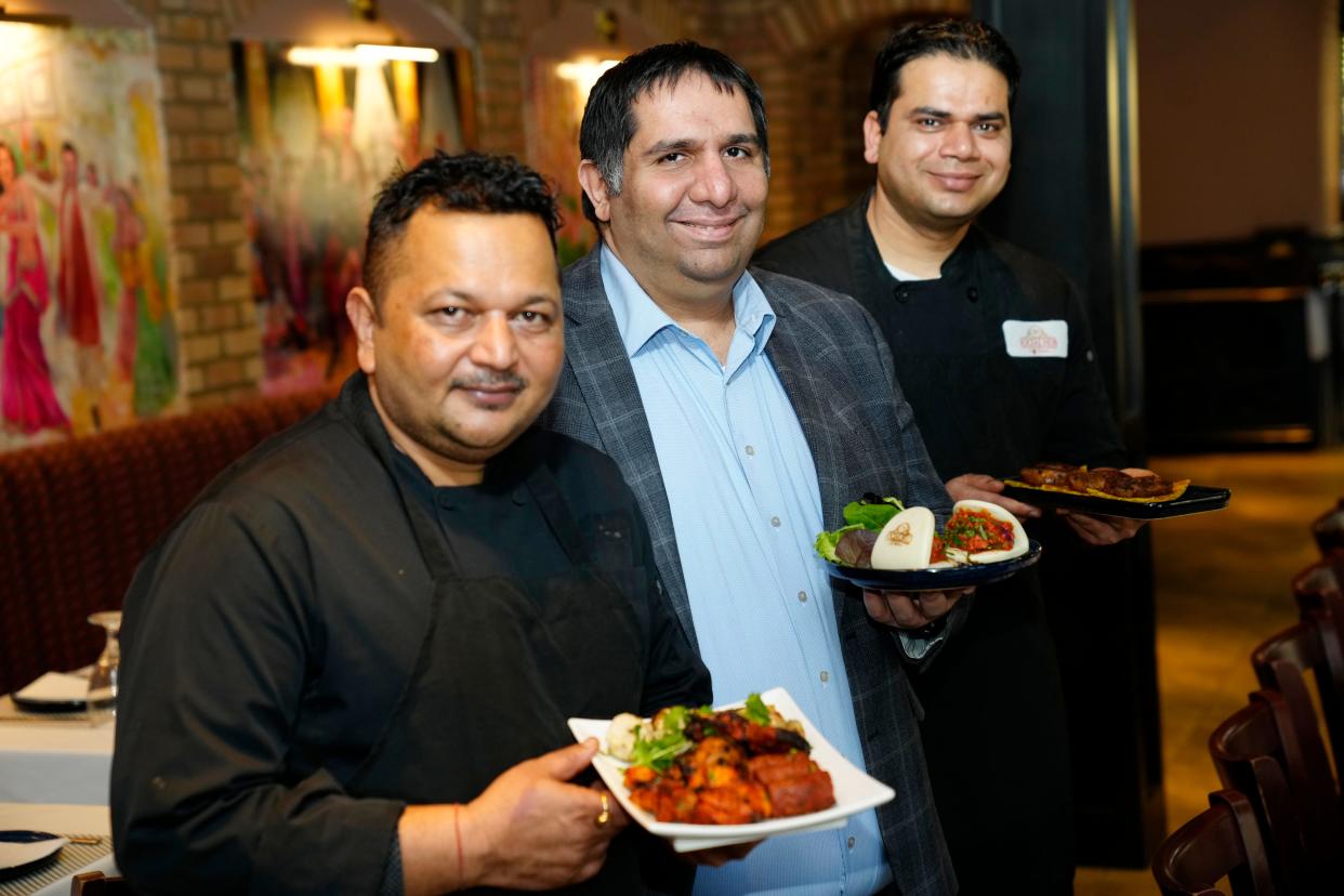 Ankush Punhani (center), owner of Social Hub by Dhaba, poses for a photograph with chefs, Rakesh Kumar and Himanshu Joshi.