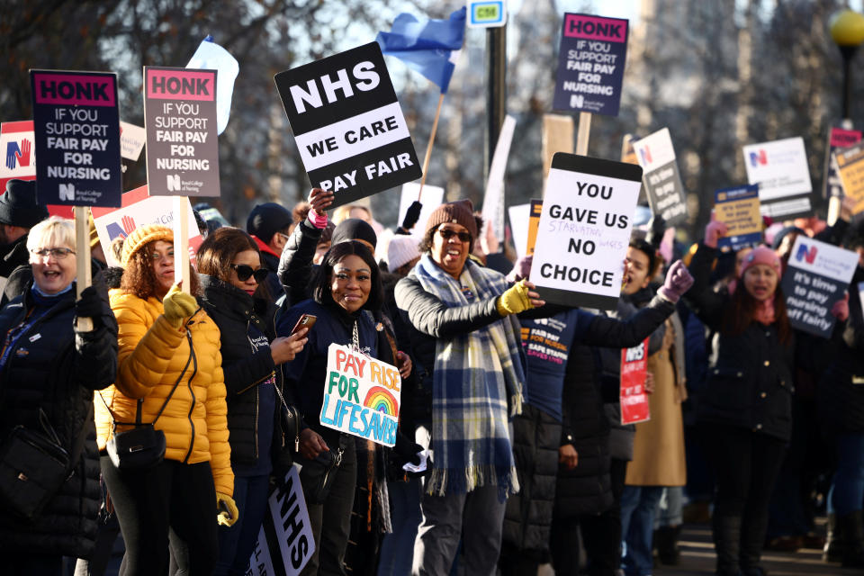 NHS nurses hold placards during a strike, amid a dispute with the government over pay, outside St Thomas' Hospital in London, Britain December 15, 2022. REUTERS/Henry Nicholls