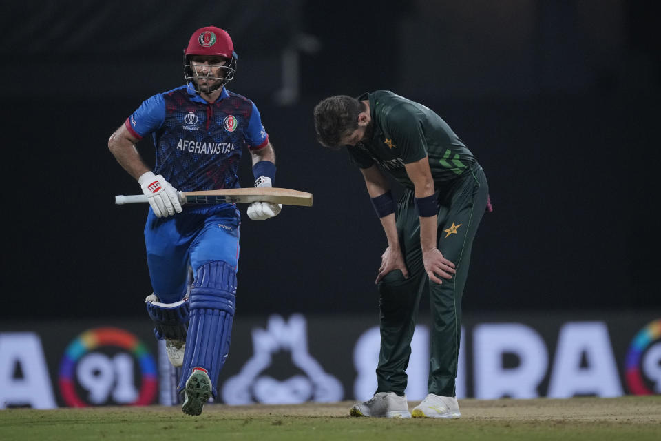 Pakistan's Shaheen Afridi, right, reacts as Afghanistan's Rahmat Shah run between the wickets during the ICC Men's Cricket World Cup match between Pakistan and Afghanistan in Chennai , India, Monday, Oct. 23, 2023. (AP Photo/Anupam Nath)