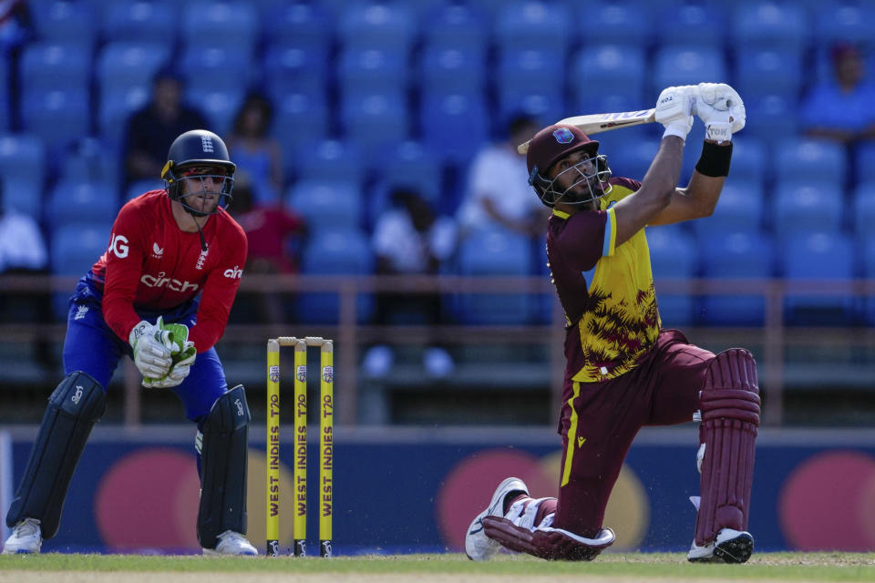 West Indies' Brandon King hits a six from the bowling of England's Rehan Ahmed during the second T20 cricket match at National Cricket Stadium in Saint George's, Grenada, Thursday, Dec. 14, 2023. (AP Photo/Ricardo Mazalan)