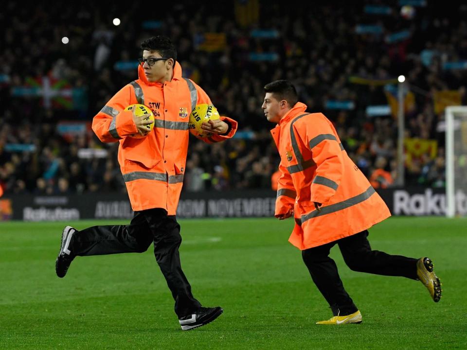 Protesters forced the Clasico to be temporarily halted by throwing balls onto the pitch: Getty
