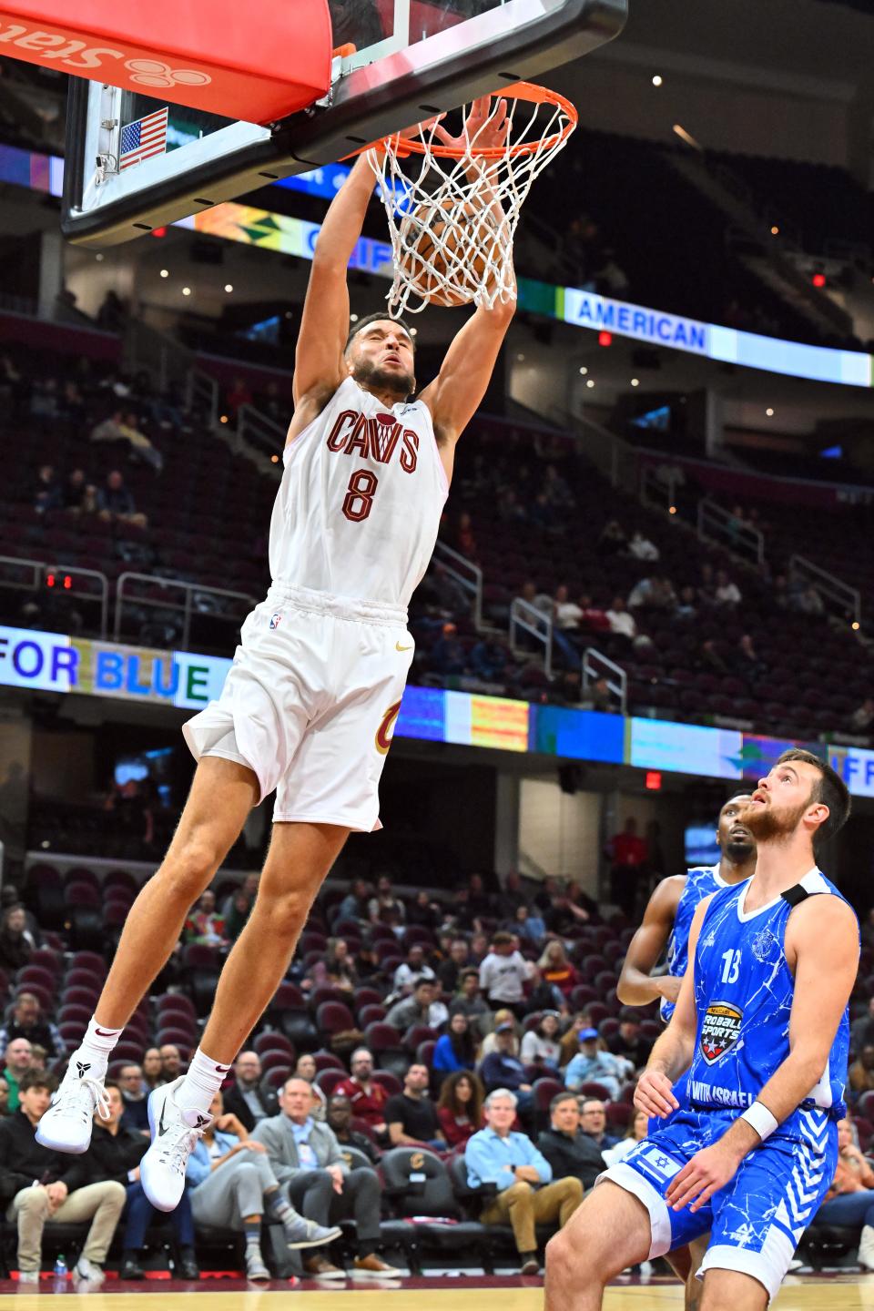 Cleveland Cavaliers forward Pete Nance dunks over Maccabi Ra'anana's Yoav Berman during a preseason game Oct. 16, 2023, in Cleveland.