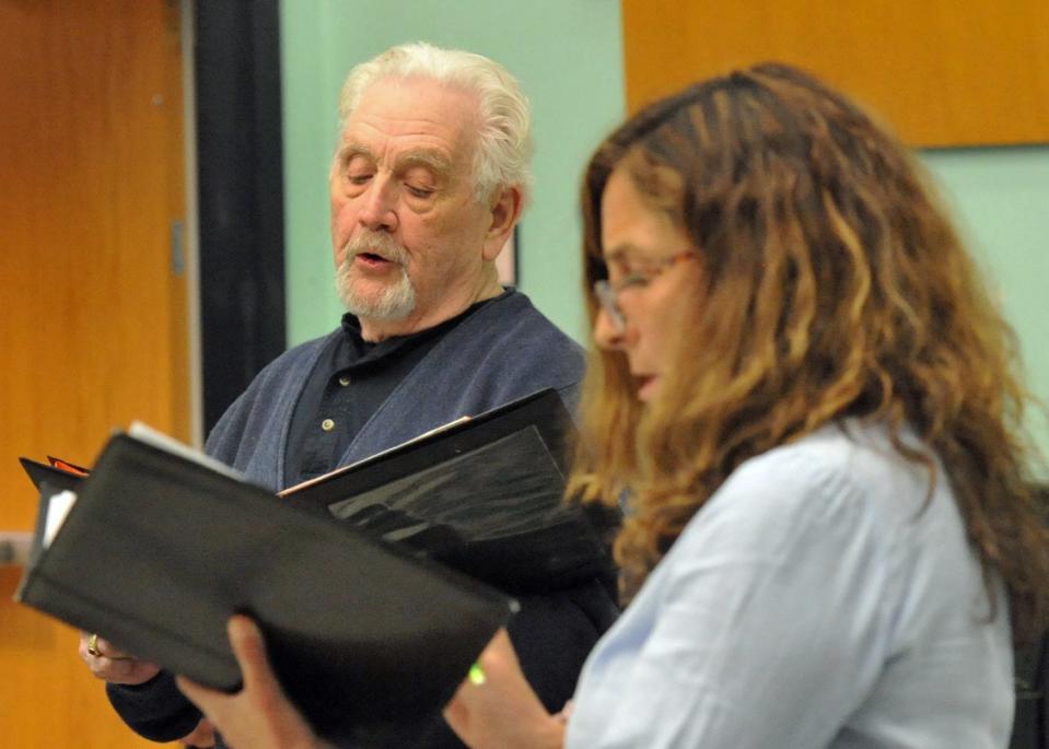 Snug Harbor Community Chorus members Ken Sennott, of Middleboro, left, and Caroline Nowak, of Norwell, right, rehearse for their 25th anniversary concert at the Duxbury Performing Arts Center. Monday, May 3, 2022.