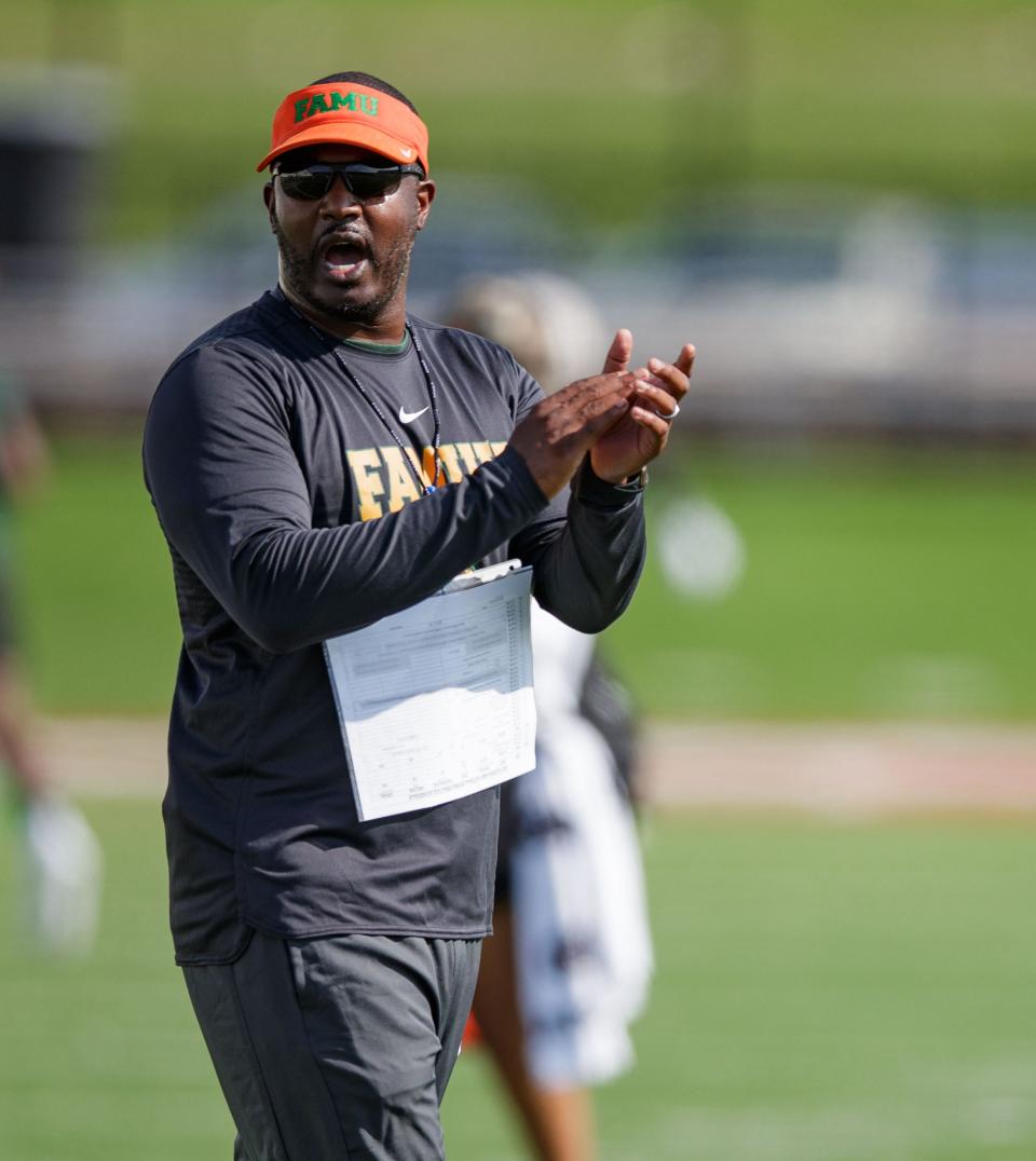 Florida A&M University football head coach Willie Simmons cheers on his players during fall camp.