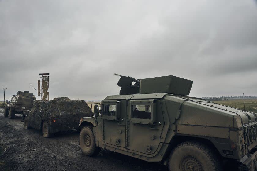 Ukrainian military vehicles move on the road in the freed territory in the Kharkiv region, Ukraine, Monday, Sept. 12, 2022. Ukrainian troops retook a wide swath of territory from Russia on Monday, pushing all the way back to the northeastern border in some places, and claimed to have captured many Russian soldiers as part of a lightning advance that forced Moscow to make a hasty retreat. (AP Photo/Kostiantyn Liberov)