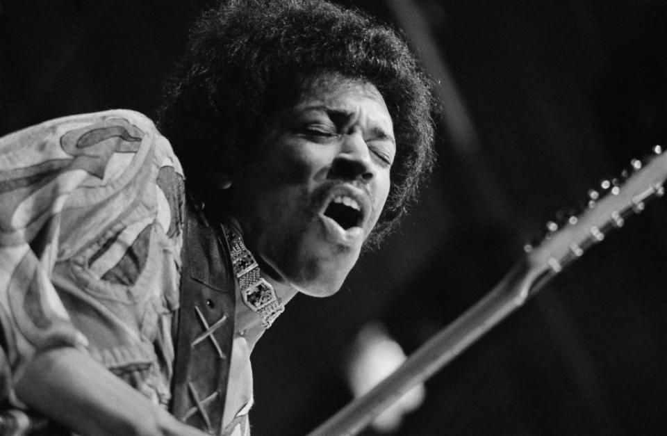 Close-up of Jimi Hendrix playing guitar onstage
