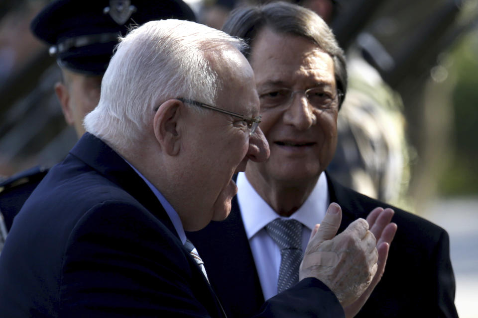 Cyprus' president Nicos Anastasiades, right, and Israel's President Reuven Rivlin review a military guard of honor during a welcoming ceremony at the presidential palace in divided capital Nicosia, Cyprus, on Tuesday, Feb. 12, 2019. Rivlin is in Cyprus for one-day official visit for talks. (AP Photo/Petros Karadjias)