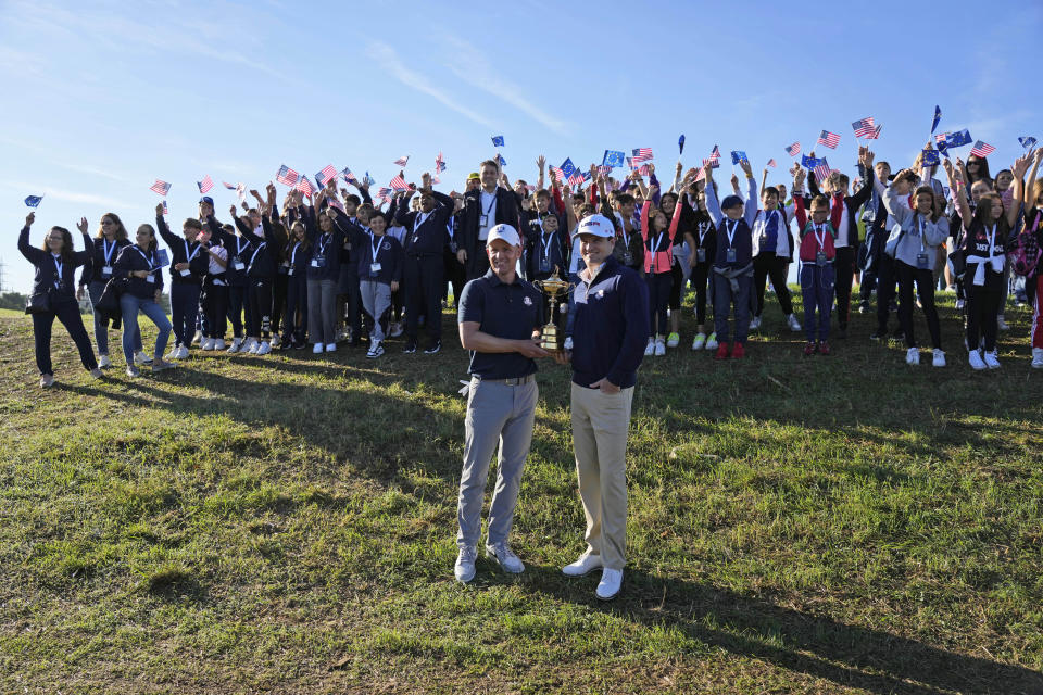 European Captain Luke Donald, left, and United States Captain Zach Johnson pose with the Ryder Cup trophy before an exhibition match on the occasion of The Year to Go event at the Marco Simone course that will host the 2023 Ryder Cup, in Guidonia Montecelio, near Rome, Italy, Monday, Oct. 3, 2022. (AP Photo/Alessandra Tarantino)