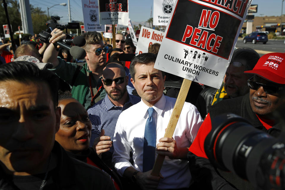 Democratic presidential candidate former South Bend, Ind., Mayor Pete Buttigieg walks on a picket line with members of the Culinary Workers Union Local 226 outside the Palms Casino in Las Vegas, Wednesday, Feb. 19, 2020. (AP Photo/Patrick Semansky)