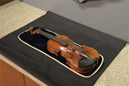 The 300-year-old Stradivarius violin that was taken from the Milwaukee Symphony Orchestra's concertmaster in an armed robbery is pictured in Milwaukee, Wisconsin in this February 6, 2014 handout photo at a news conference after it was recovered. REUTERS/Jon D. Riemann/Milwaukee Police/Handout via Reuters