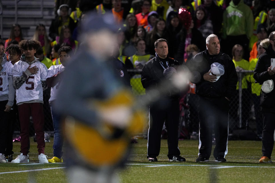 Singer James Taylor sings the national anthem as Edward Little High School players and first responders stand together, Wednesday, Nov. 1, 2023, prior to a high school football game in Lewiston, Maine. Locals seek a return to normalcy after a mass shooting on Oct. 25. (AP Photo/Matt York)