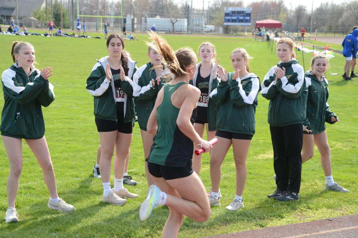 Bella LaFountain is cheered on by her St. Mary Catholic Central teammates as she runs the 3,200-meter relay against Jefferson Tuesday.