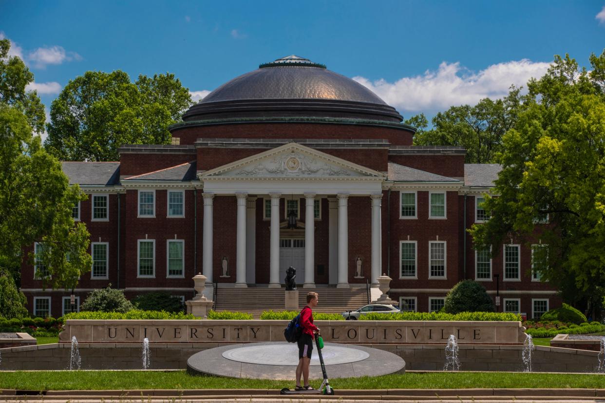 A student rides a Bird scooter past Grawemeyer Hall Tuesday on the University of Louisville campus. May 14, 2019