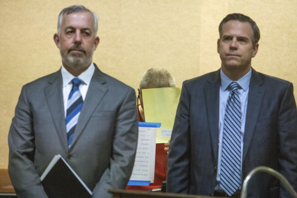 Defense attorney Jonathan McDougall, right, and Eric Hove, left, stand in front of Chunli Zhao as he appears for his arraignmentat San Mateo Superior Court in Redwood City, Calif., on Wednesday, Jan. 25, 2023. Zhao, a farmworker accused of killing seven people in back-to-back shootings at two Northern California mushroom farms was charged Wednesday with seven counts of murder and one of attempted murder. Zhao, 66, made his first court appearance. (Shae Hammond/Bay Area News Group via AP, Pool)