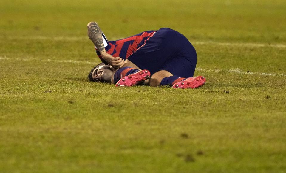 United States' Christian Pulisic grimaces after being fouled during a qualifying soccer match for the FIFA World Cup Qatar 2022, against Honduras in San Pedro Sula, Honduras, Wednesday, Sept. 8, 2021. (AP Photo/Moises Castillo)