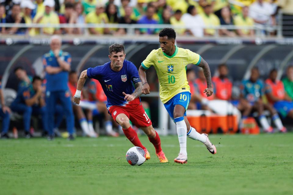 The USMNT's Christian Pulisic (10) controls the ball while defended by Brazil's Rodrygo during the first half at Camping World Stadium.