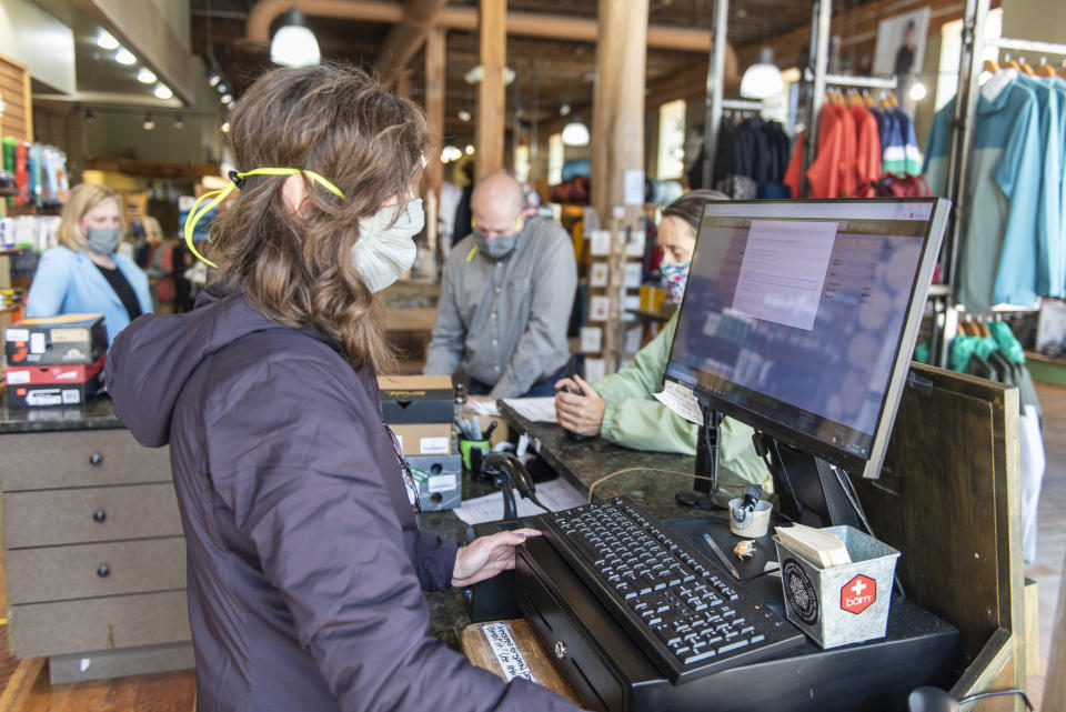 BOZEMAN, MT - MAY 04: Sales staff wear masks at the reopened Schnee's Boots, Shoes and Outdoors on Main Street on May 4, 2020 in Bozeman, Montana. Wyoming health officials today reported that the state's confirmed coronavirus cases grew by nine to a total of 444. (Photo by William Campbell/Getty Images)