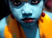 A child dressed as Hindu god Krishna looks on during festivities to mark Janmashtami at a school in Mumbai, India, Sept. 1, 2010. Janmashtami is the festival that marks the birth of Krishna. (AP Photo/Rajanish Kakade)