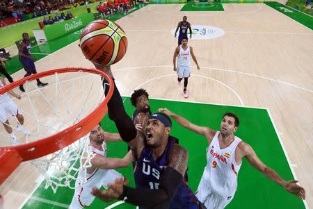 Aug 19, 2016; Rio de Janeiro, Brazil; USA forward Carmelo Anthony (15) lays the ball up past Spain center Felipe Reyes (9) during the men's basketball semifinal match in the Rio 2016 Summer Olympic Games at Carioca Arena 1. Mandatory Credit: Jeff Swinger-USA TODAY Sports