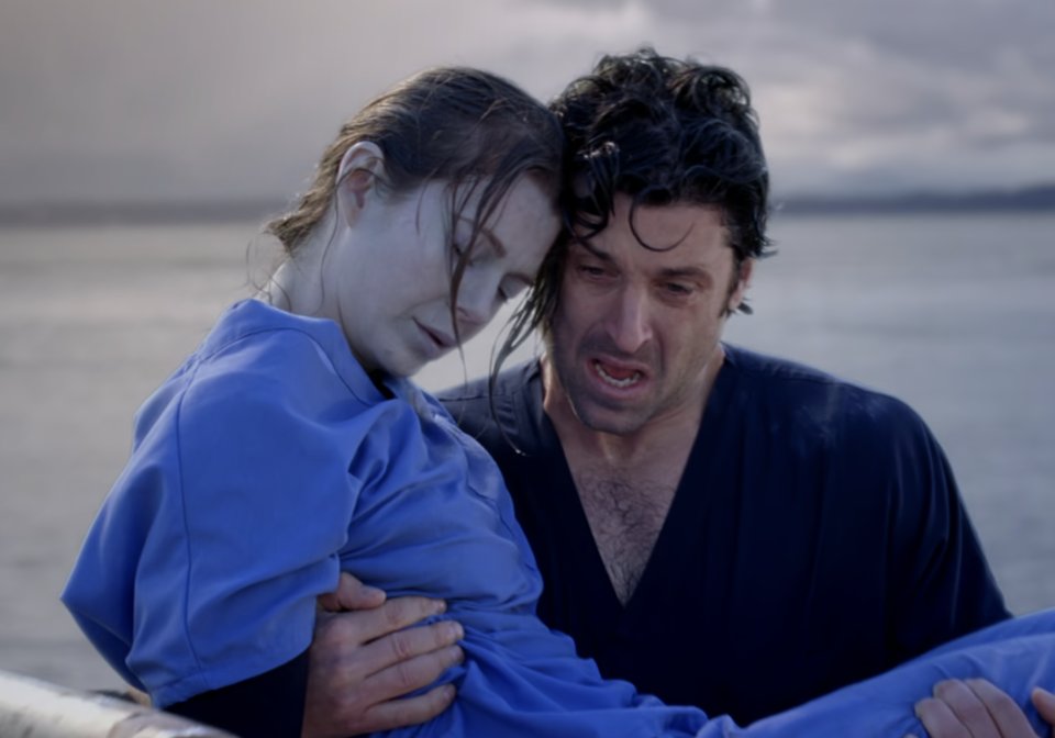 McDreamy carrying an unconscious Meredith Grey in Grey's Anatomy with water behind them