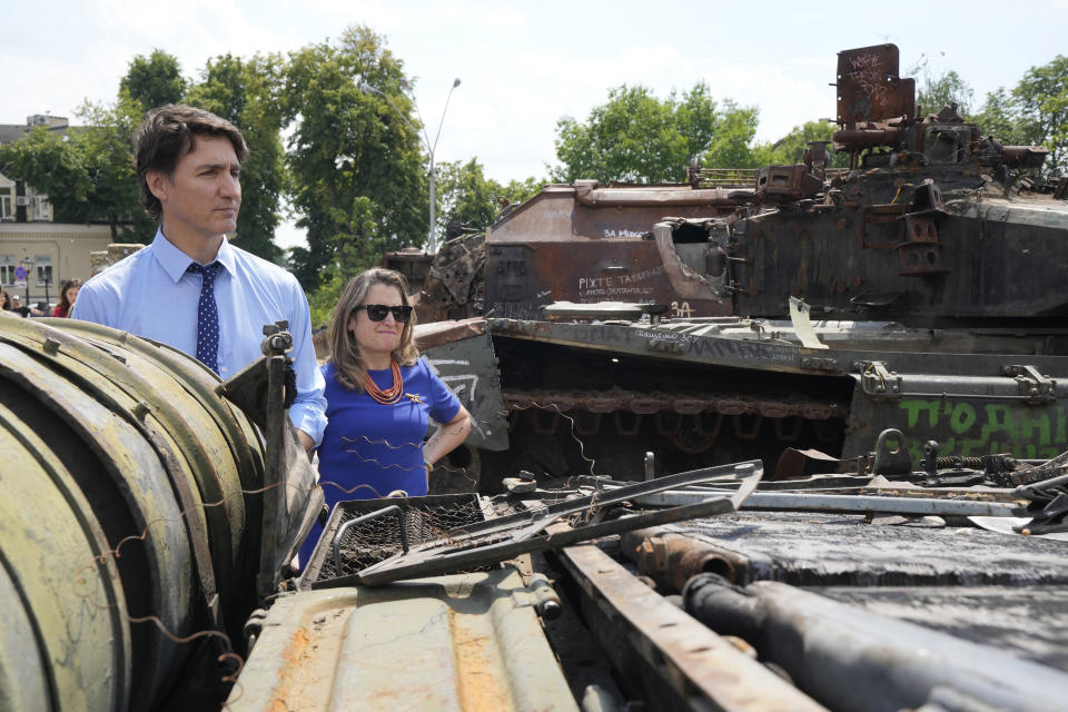 Canadian Prime Minister Justin Trudeau, left, and Deputy Prime Minister Chrystia Freeland look at burned out Russian tanks in Kyiv, Ukraine, on Saturday, June 10, 2023. (Frank Gunn/The Canadian Press via AP)