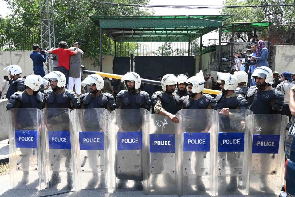 Pakistani security officials stand guard outside the Lahore high court where Imran Khan appeared for bail on 19 May (EPA)